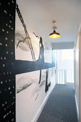 a wall with a painting of dolphins on it at The Docklands Apartment by Serviced Living Liverpool in Liverpool