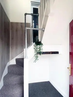 a staircase in a house with a plant at The Docklands Apartment by Serviced Living Liverpool in Liverpool