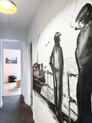 a room with a painting on the wall at The Docklands SA by Serviced Living Liverpool in Liverpool