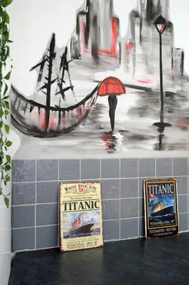 a painting of a man with an umbrella and a boat at The Docklands SA by Serviced Living Liverpool in Liverpool