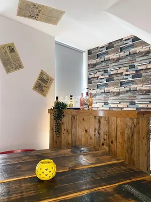 a dining room with a wooden table with a yellow bowl at The Docklands SA by Serviced Living Liverpool in Liverpool