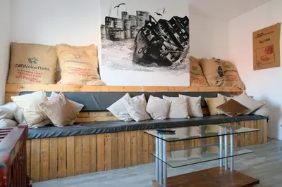 a couch with pillows on it in a room at The Docklands SA by Serviced Living Liverpool in Liverpool