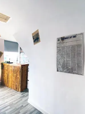 a living room with a newspaper on the wall at The Docklands SA by Serviced Living Liverpool in Liverpool