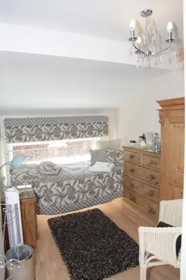 a bedroom with a bed and a dresser at The Leicester in Southport