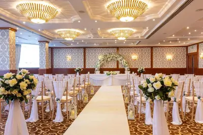 a banquet hall with tables and chairs and flowers at Grand Hotel Blackpool in Blackpool