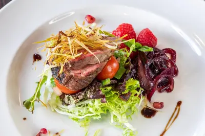 a white plate with a salad with meat and fruit at Grand Hotel Blackpool in Blackpool