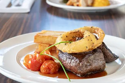 a plate of food with meat and bread on a table at Grand Hotel Blackpool in Blackpool