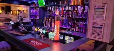 a bar with a lot of bottles of alcohol at The Clarendon Hotel in Morecambe