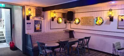 a bar with chairs and a table in a restaurant at The Clarendon Hotel in Morecambe