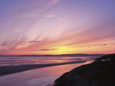 a sunset over the water at the beach at The Clarendon Hotel in Morecambe
