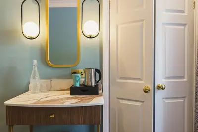 a bathroom with a sink and a mirror at Grange Hotel in Grange Over Sands