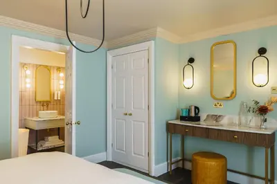 a bedroom with a sink and a mirror at Grange Hotel in Grange Over Sands