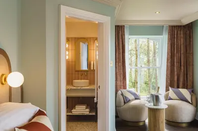 a bedroom with a bed and a mirror at Grange Hotel in Grange Over Sands