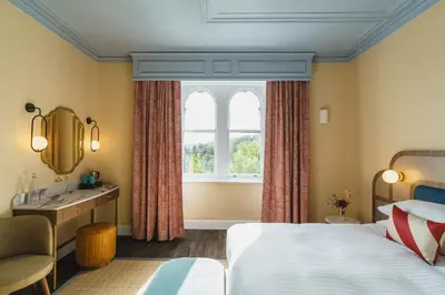 a hotel room with a bed and a window at Grange Hotel in Grange Over Sands