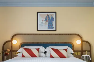 a bedroom with a large bed with red and white pillows at Grange Hotel in Grange Over Sands