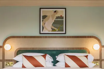 a picture of a woman is above a bed at Grange Hotel in Grange Over Sands