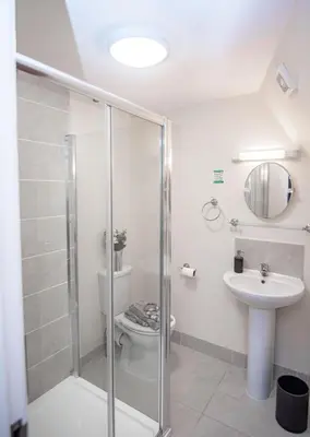 a bathroom with a shower and a toilet and a sink at MARS Hotel Seaview Blackpool in Blackpool