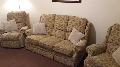 a living room with a couch and a chair at delamere holiday apartments in Blackpool