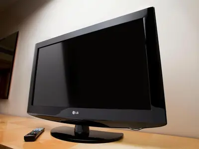 a computer monitor on a desk with a remote control at Holiday Inn Lancaster by IHG in Lancaster