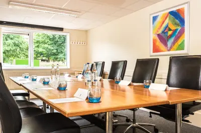 a conference room with a long wooden table and chairs at Holiday Inn Lancaster by IHG in Lancaster