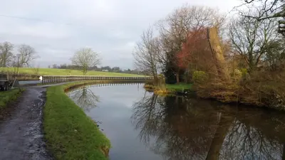 a bridge over a river in a park at Lunecliffe Country lodge-Lancaster Gateway to the Lakes in Lancaster