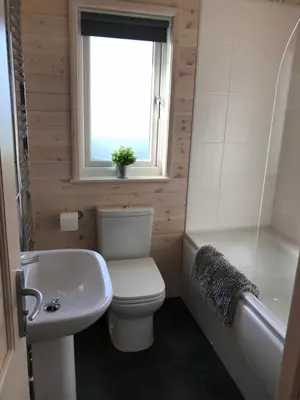 a bathroom with a toilet and a sink and a window at Lunecliffe Country lodge-Lancaster Gateway to the Lakes in Lancaster