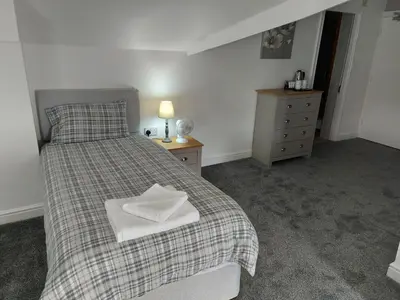 a bedroom with a bed with a pillow on it at Ambrose Hotel in Barrow in Furness