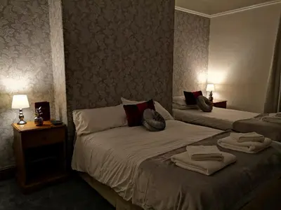 a hotel room with two beds with towels on them at Ambrose Hotel in Barrow in Furness