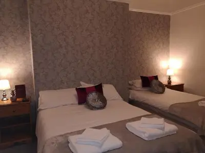 a hotel room with two beds with towels on them at Ambrose Hotel in Barrow in Furness