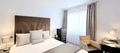 a bedroom with a bed and a desk and a chair at Mode Hotel St Annes in Lytham St Annes