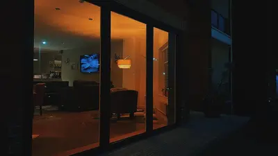 a view of a living room at night with a window at Mode Hotel St Annes in Lytham St Annes