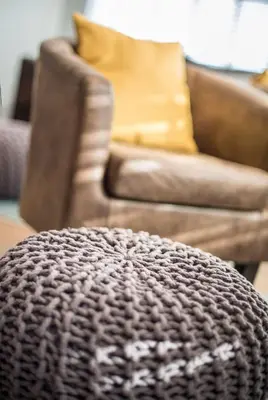 a living room with a couch and a chair at Mode Hotel St Annes in Lytham St Annes