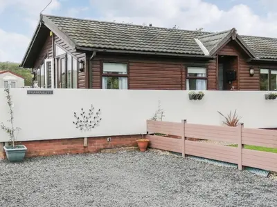 a house with a white fence in front of it at Tranquillity in Millom