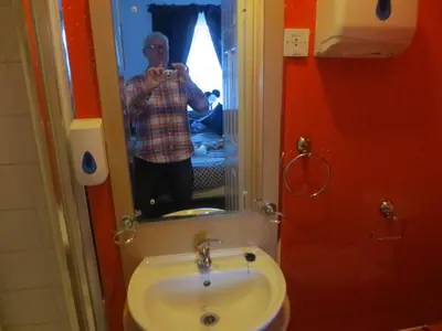 a man taking a picture of himself in a bathroom mirror at The Salendine in Blackpool