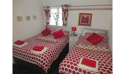 two beds sitting next to each other in a bedroom at The Salendine in Blackpool