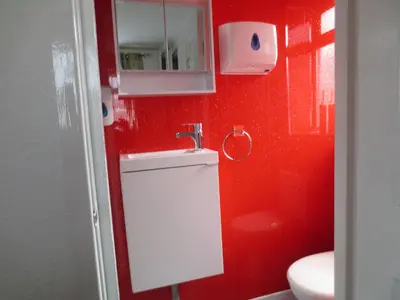 a red bathroom with a sink and a toilet at The Salendine in Blackpool