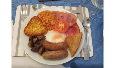 a plate of breakfast food with eggs sausage beans and toast at The Salendine in Blackpool