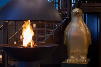 a fire pit with a bird statue next to it at Malmaison Liverpool in Liverpool