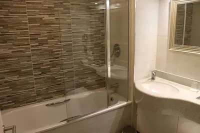 a bathroom with a shower and a sink at The Villa Country House Hotel in Wrea Green