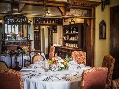 a dining room with a table with flowers on it at The Villa Country House Hotel in Wrea Green