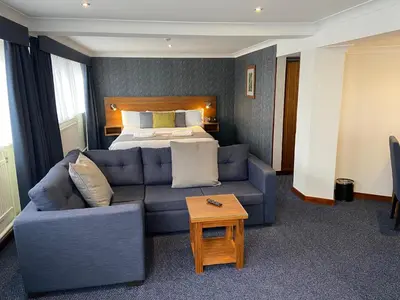 a hotel room with a couch and a bed at The Liner at Liverpool in Liverpool