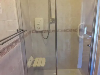 a bathroom with a shower with a glass door at Lancaster Townhouse in Lancaster