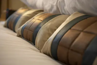 a row of lined up pillows on a bed at Lancaster House Hotel in Lancaster