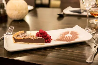 a piece of cake on a plate on a table at Lancaster House Hotel in Lancaster