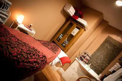 a bedroom with a bed with a red blanket at Lancaster House Hotel in Lancaster