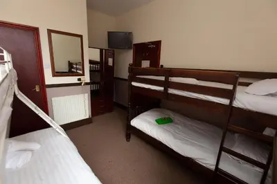 a room with two bunk beds and a mirror at The Riviera Hotel in Blackpool