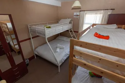 a bedroom with two bunk beds and a mirror at The Riviera Hotel in Blackpool