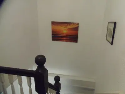 a picture of a sunset on a wall at Oban House in Blackpool