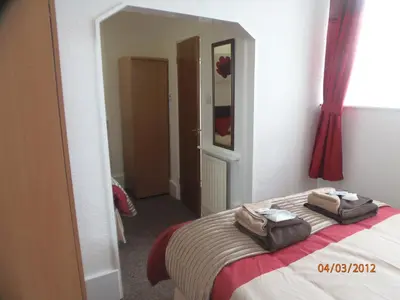a bedroom with a bed with two towels on it at Oban House in Blackpool