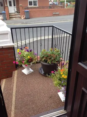 a balcony with three pots of flowers on it at Oban House in Blackpool
